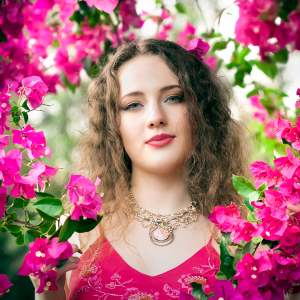 Petal light. Leah Bell in a portrait surrounded by blossoms.
