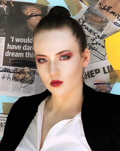 Printed lines. Leah Bell in an elegant portrait wearing a tailored suit against a newspaper backdrop.