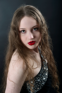 Violet ease. Leah Bell in a portrait along a jacaranda-lined street in bloom.