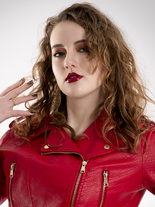 Portrait of Leah Bell in a red leather jacket. Leah Bell in a red leather jacket in a portrait photograph.