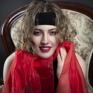 Ease in colour. Leah Bell in a relaxed portrait seated in a studio setting.