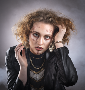 Quiet contemplation. A luminous portrait of Leah Bell, where gold tones and gentle light meet a quiet, open expression.