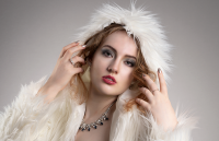 Soft frame. Leah Bell in an elegant portrait framed by a white hooded coat.